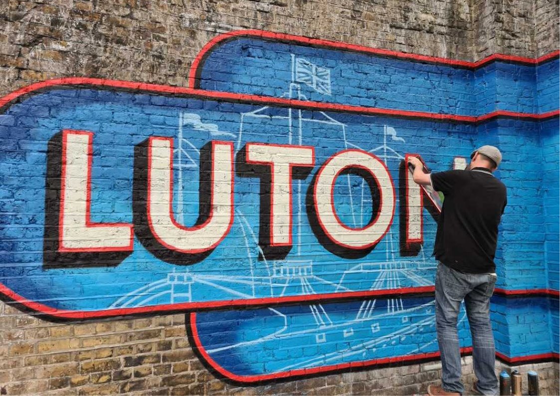 photo of painted Luton sign on wall