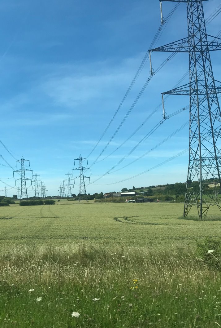 Image of electricity pylons in a field